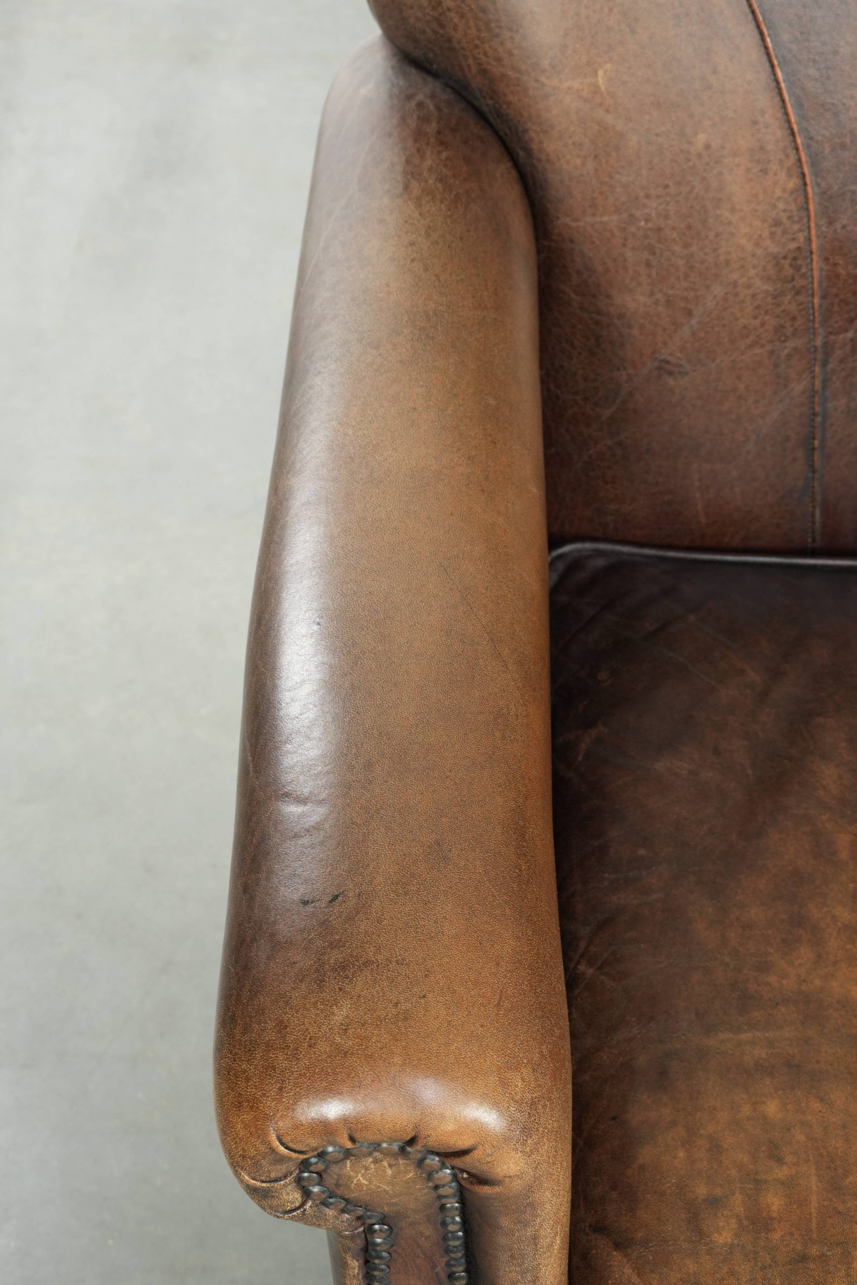 Characterful set of two sheepskin design armchairs with beautiful patina