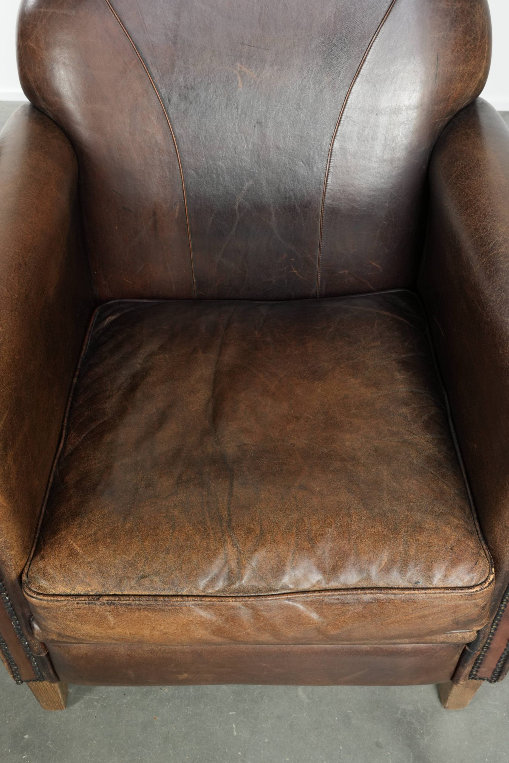 Characterful set of two sheepskin design armchairs with beautiful patina