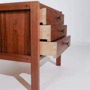 Pair of vintage Scandinavian bedside tables, three drawers, honey-toned wood.