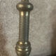 Large antique brass candlestick with floral decoration.