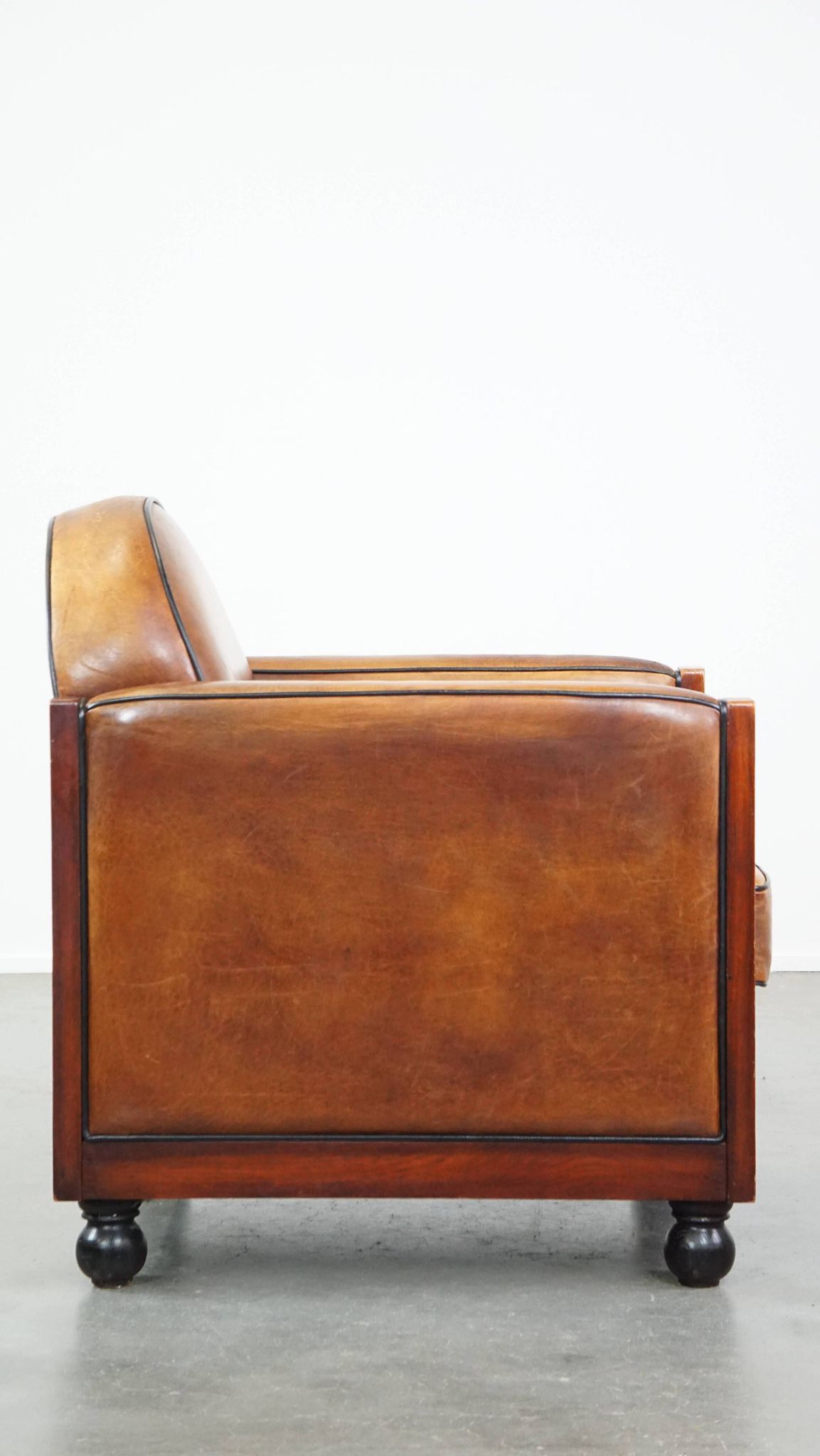Sheep leather and wooden Art Deco design armchair with ball feet