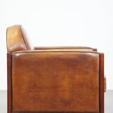 Sheep leather and wooden Art Deco design armchair with ball feet