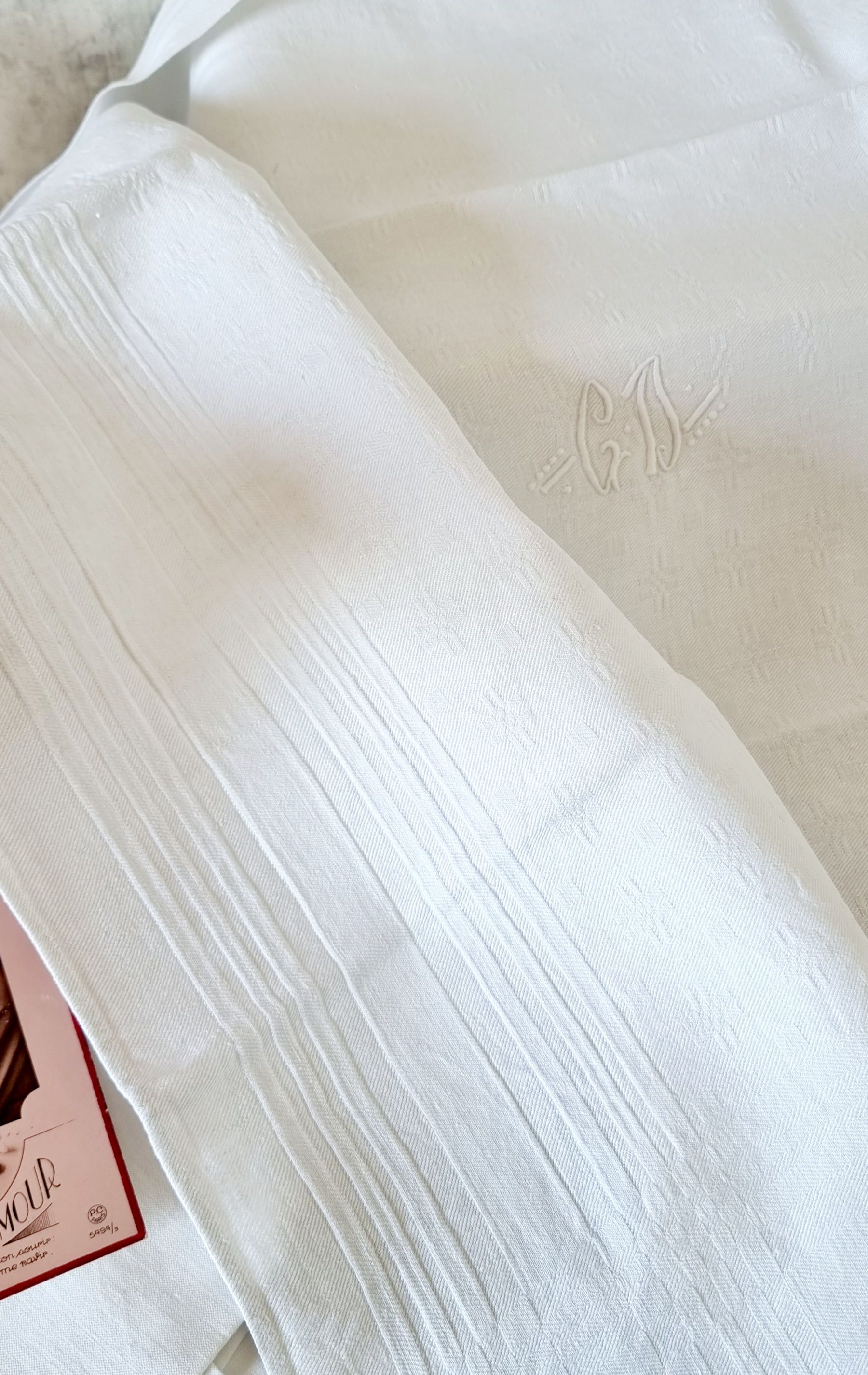 12 antique French linen towels with damask embroidery with "GB" anagrams.