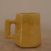 Set of two designer lemon yellow ceramic mugs