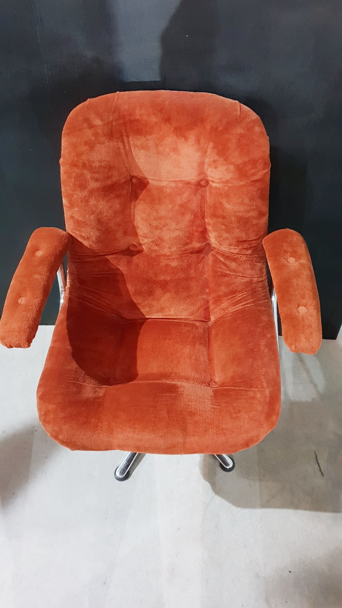 Orange velvet swivel armchair
