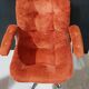 Orange velvet swivel armchair