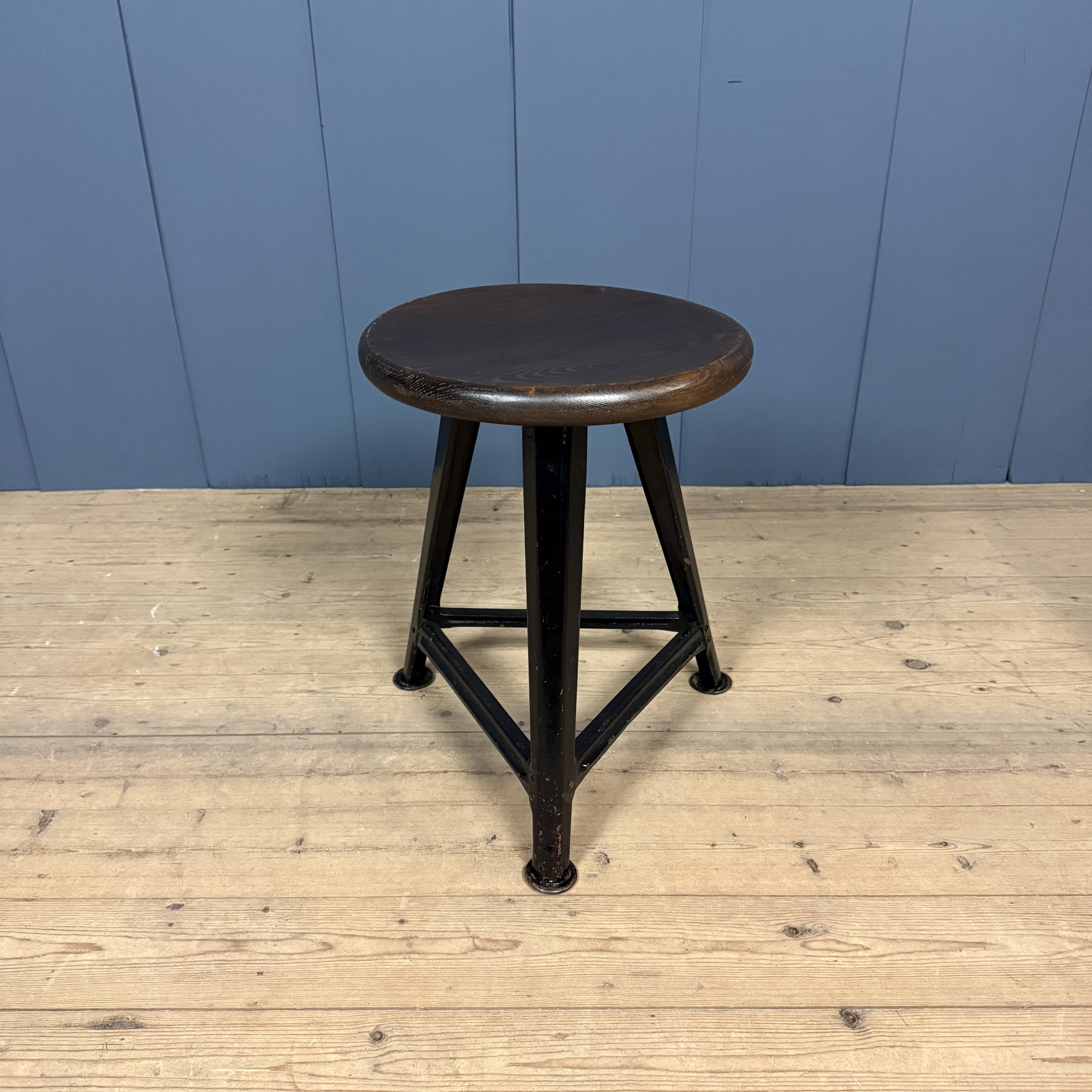 Unmarked black Rowac stool with a dark wood seat.