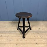 Unmarked black Rowac stool with a dark wood seat.