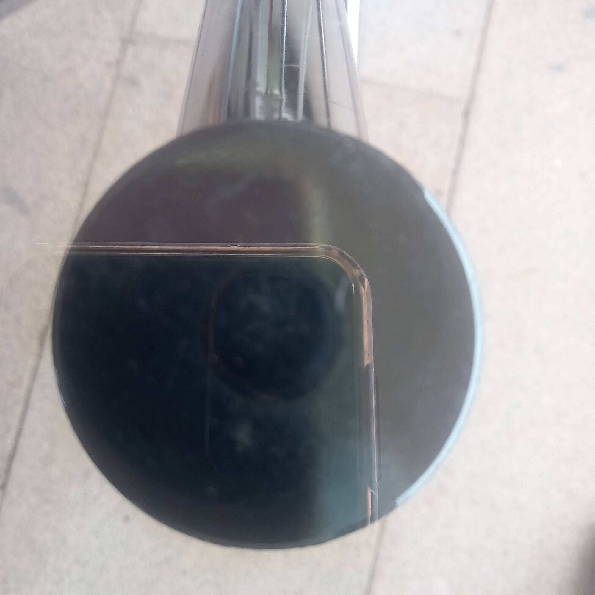 Round smoked glass table from the 70s. Foldable stainless steel legs.