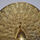 Brass pocket with peacock decoration