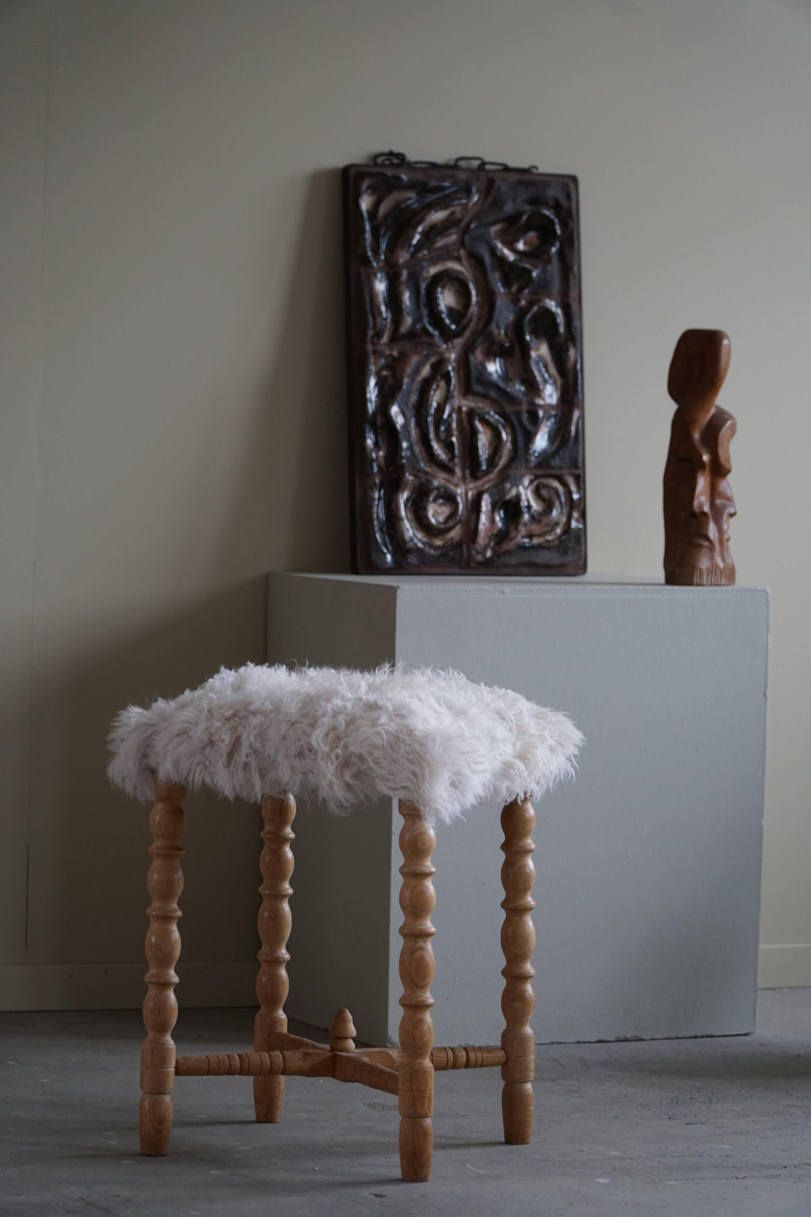 High oak stool, reupholstered in lambswool, Danish cabinetmaker, 1950s.