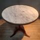 Circular pedestal table with white marble top