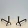 Pair of modernist fire dogs in wrought iron and brass
