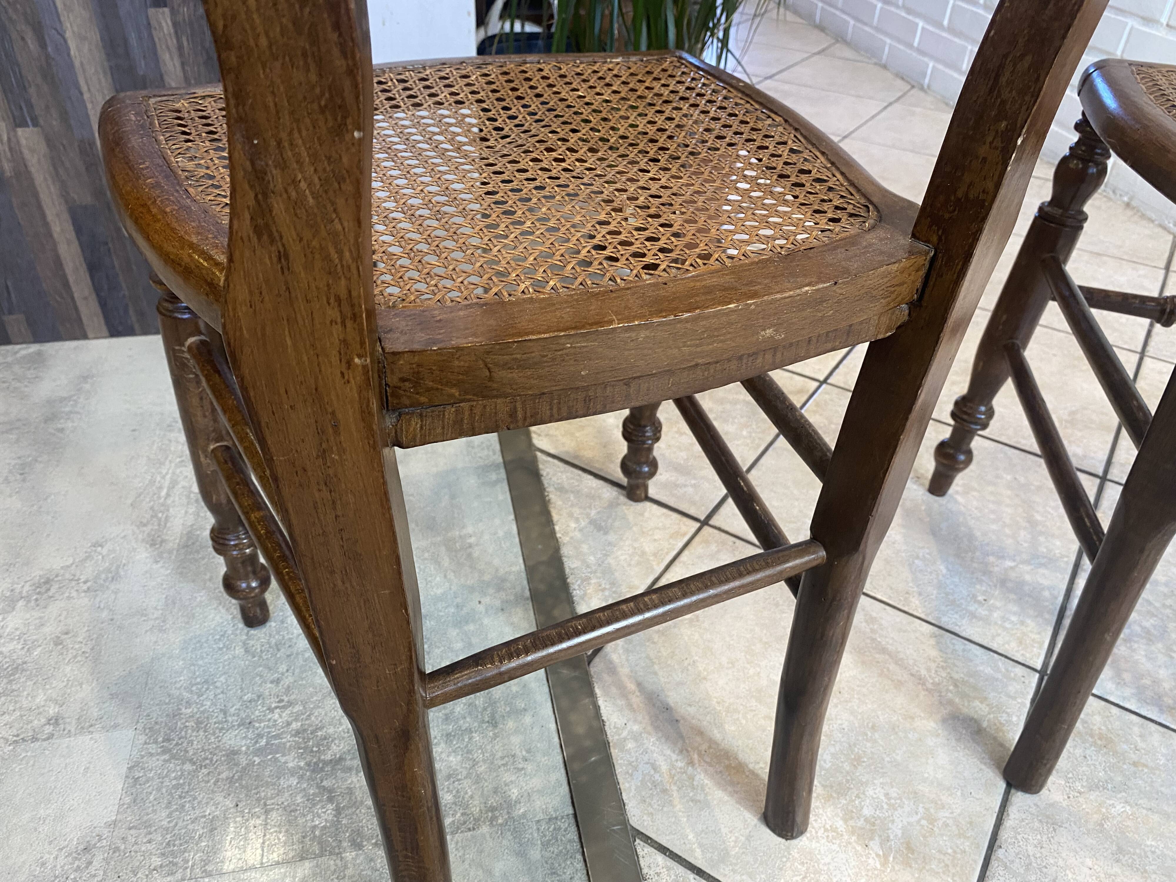 Pair of N2 antique caned and wooden chairs from the 1900s.