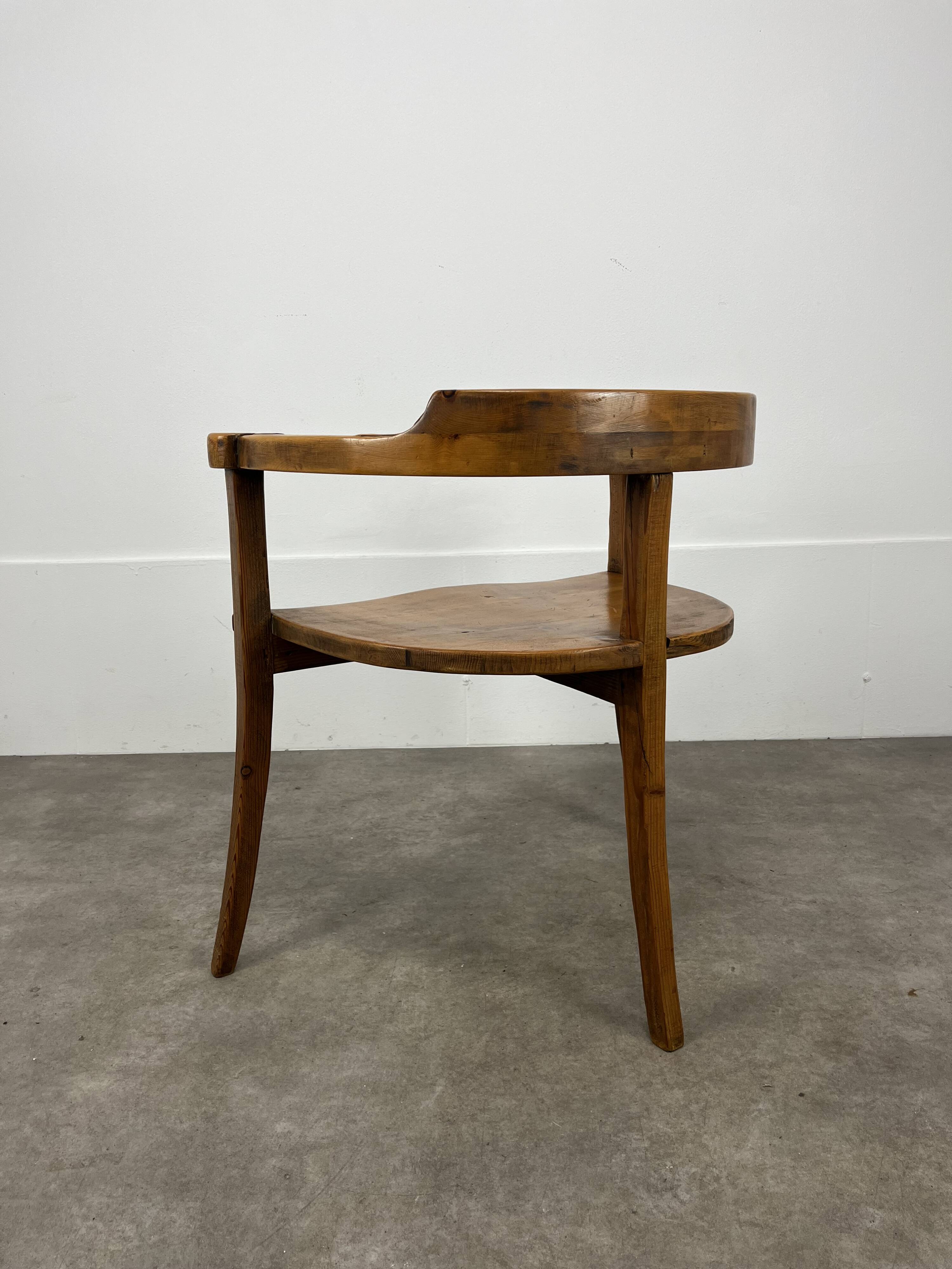 Chalet-style carved wooden tripod armchair