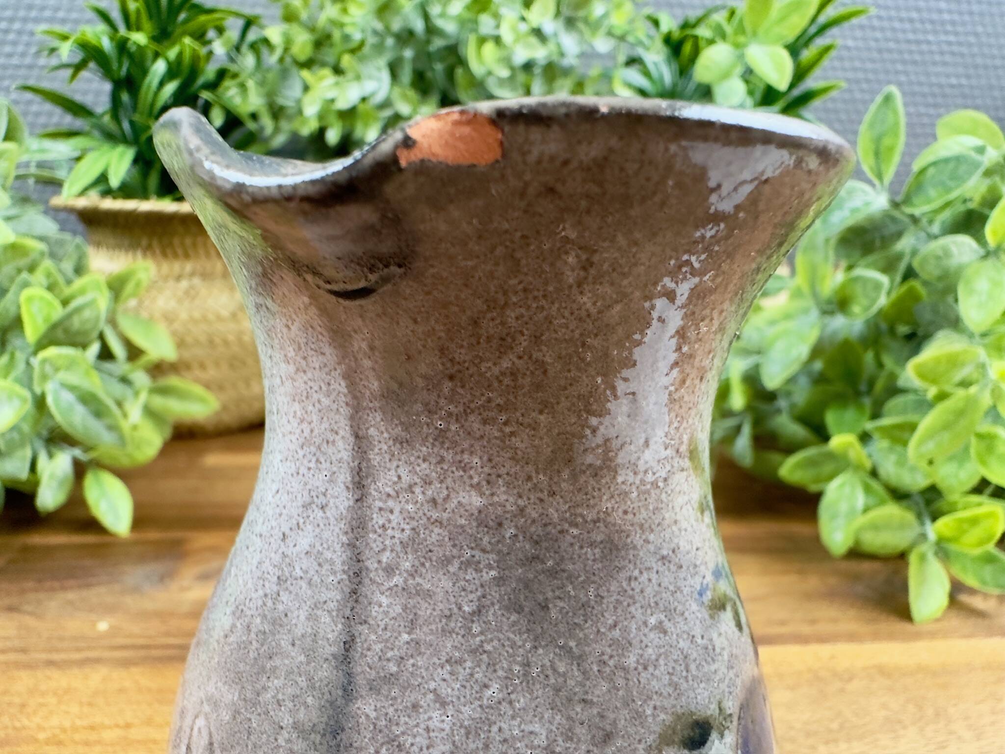 Vintage grey ceramic pitcher with hand-painted blue flower decoration.