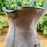 Vintage grey ceramic pitcher with hand-painted blue flower decoration.