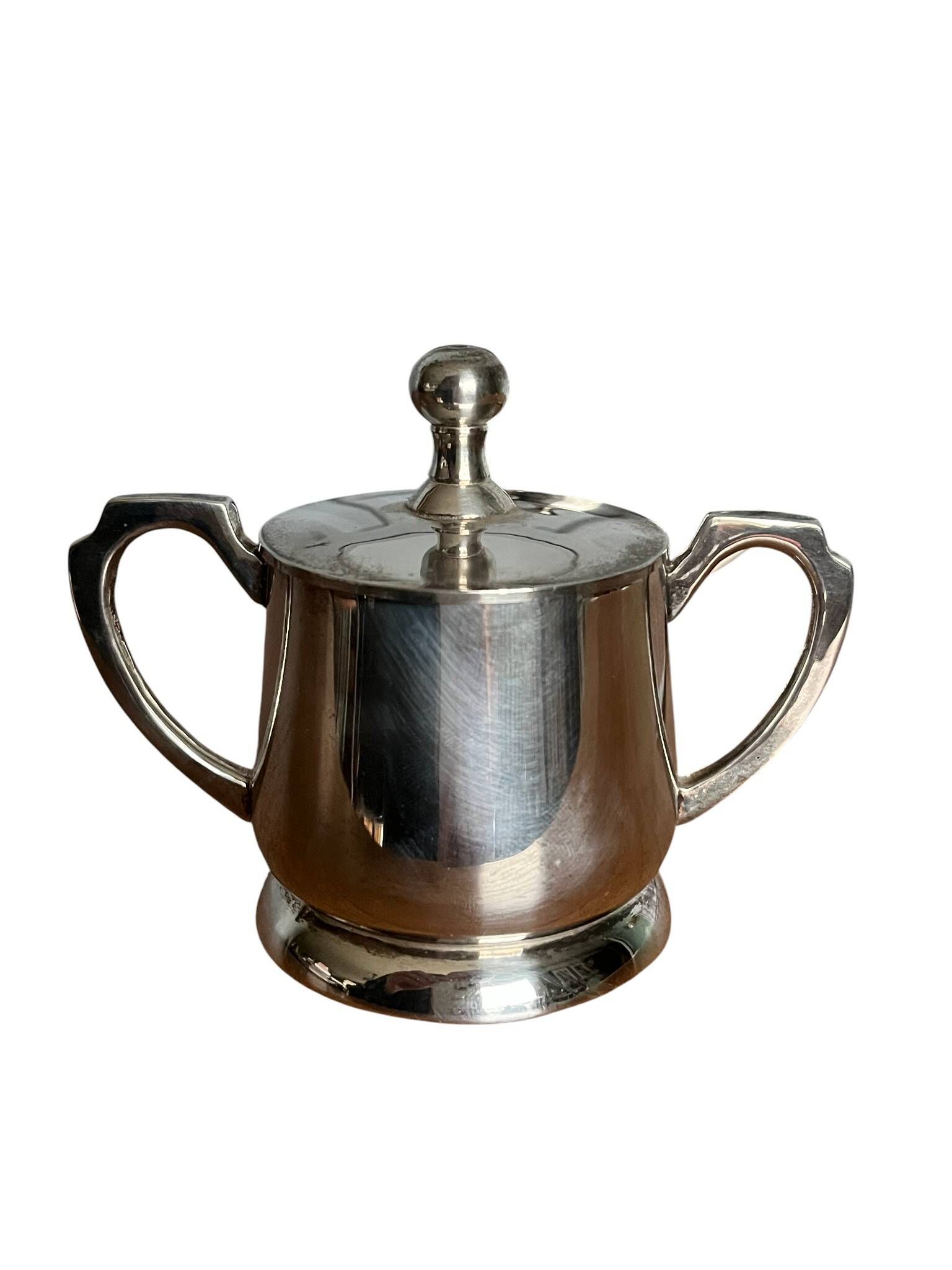 Two small silver-plated metal tea service pots from the 20th century.