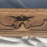 Natural wood pediment with bunches of grapes