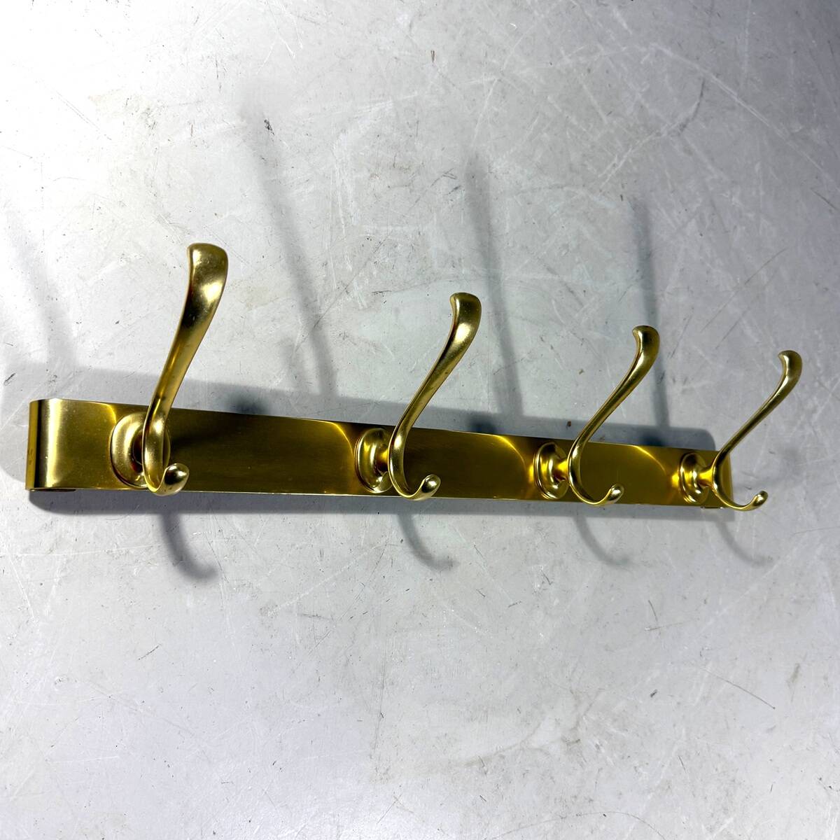 Gold coloured aluminium wall coat rack 1960’s