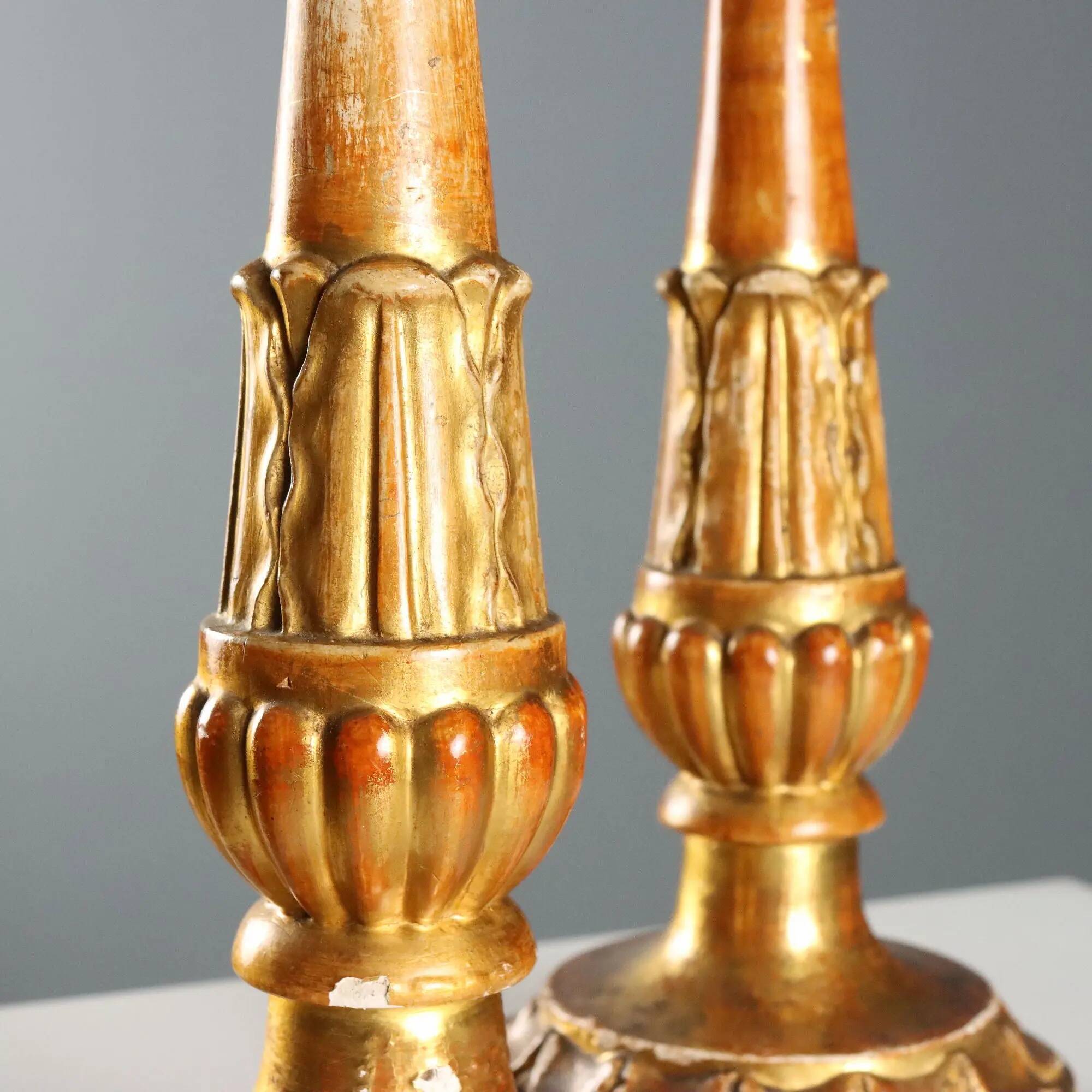 Pair of antique carved and gilded wooden candlesticks, Italy, 19th century.
