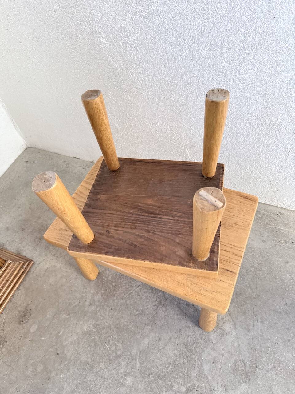 Two stools or small nesting tables in light oak.