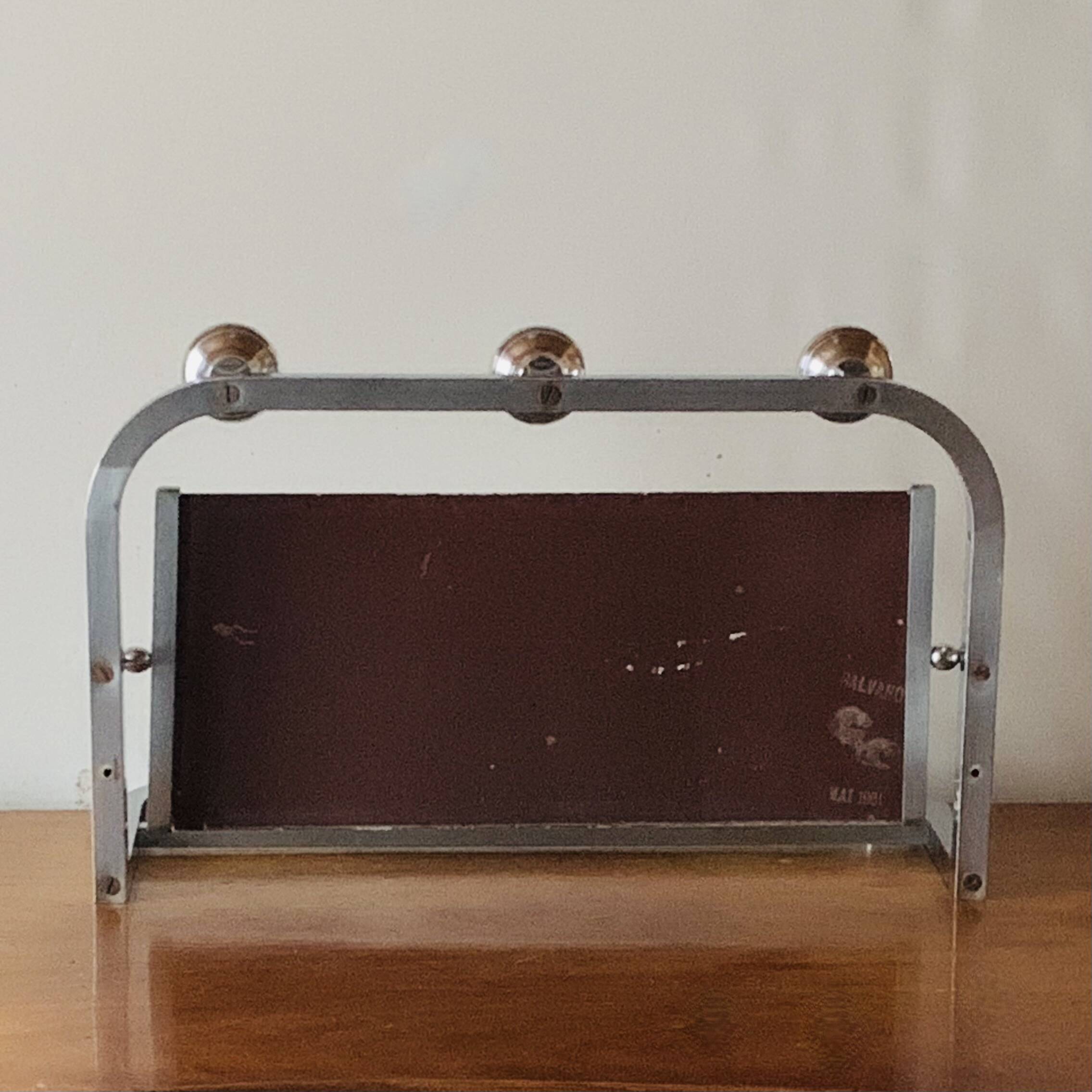 Vintage wall-mounted coat rack in chrome metal with integrated mirror and hat rack