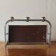 Vintage wall-mounted coat rack in chrome metal with integrated mirror and hat rack