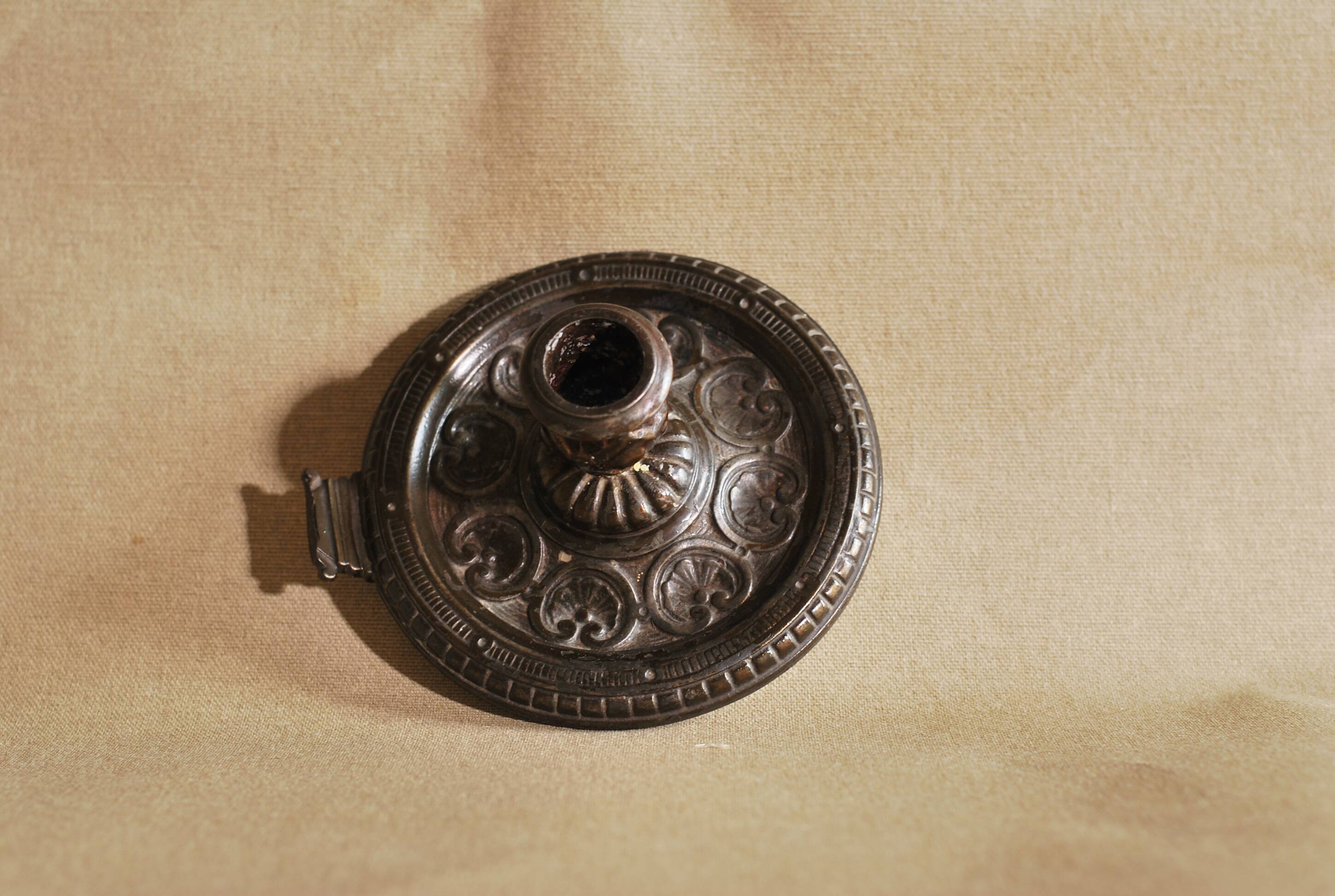 Bronze cellar rat hand candle holder