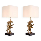 Pair of patinated brass table lamps with black granite base.