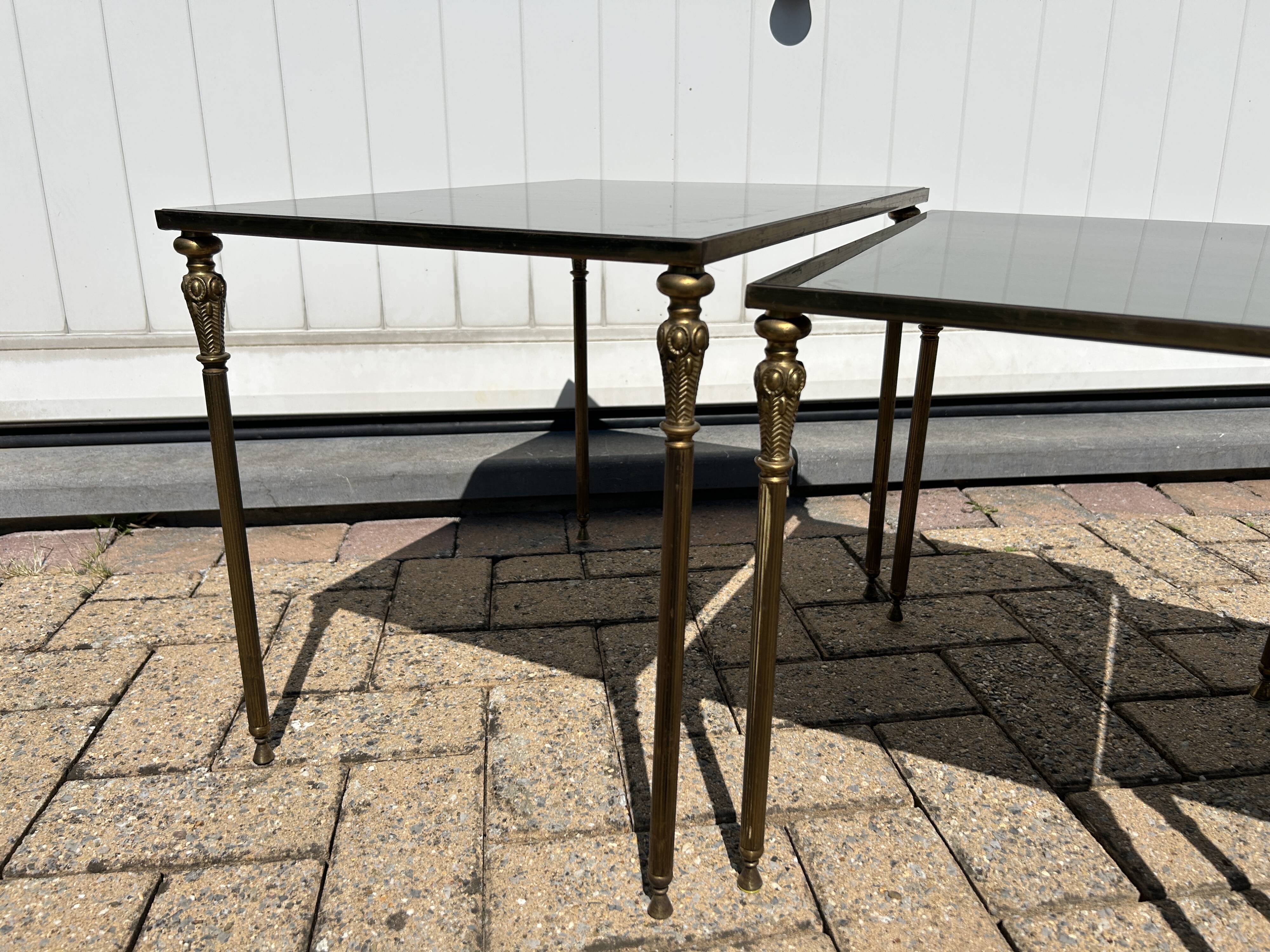 Nested tables in gilded brass in the style of Maison Charles.