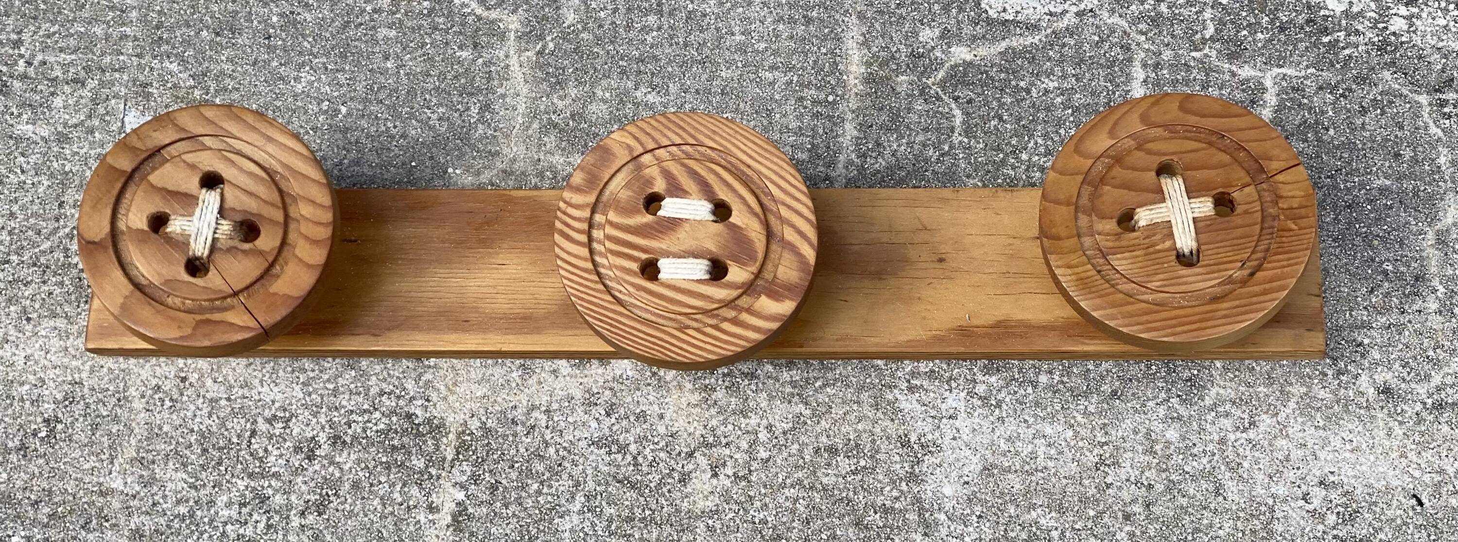 Vintage 1980 coat rack with 3 "button" hooks.