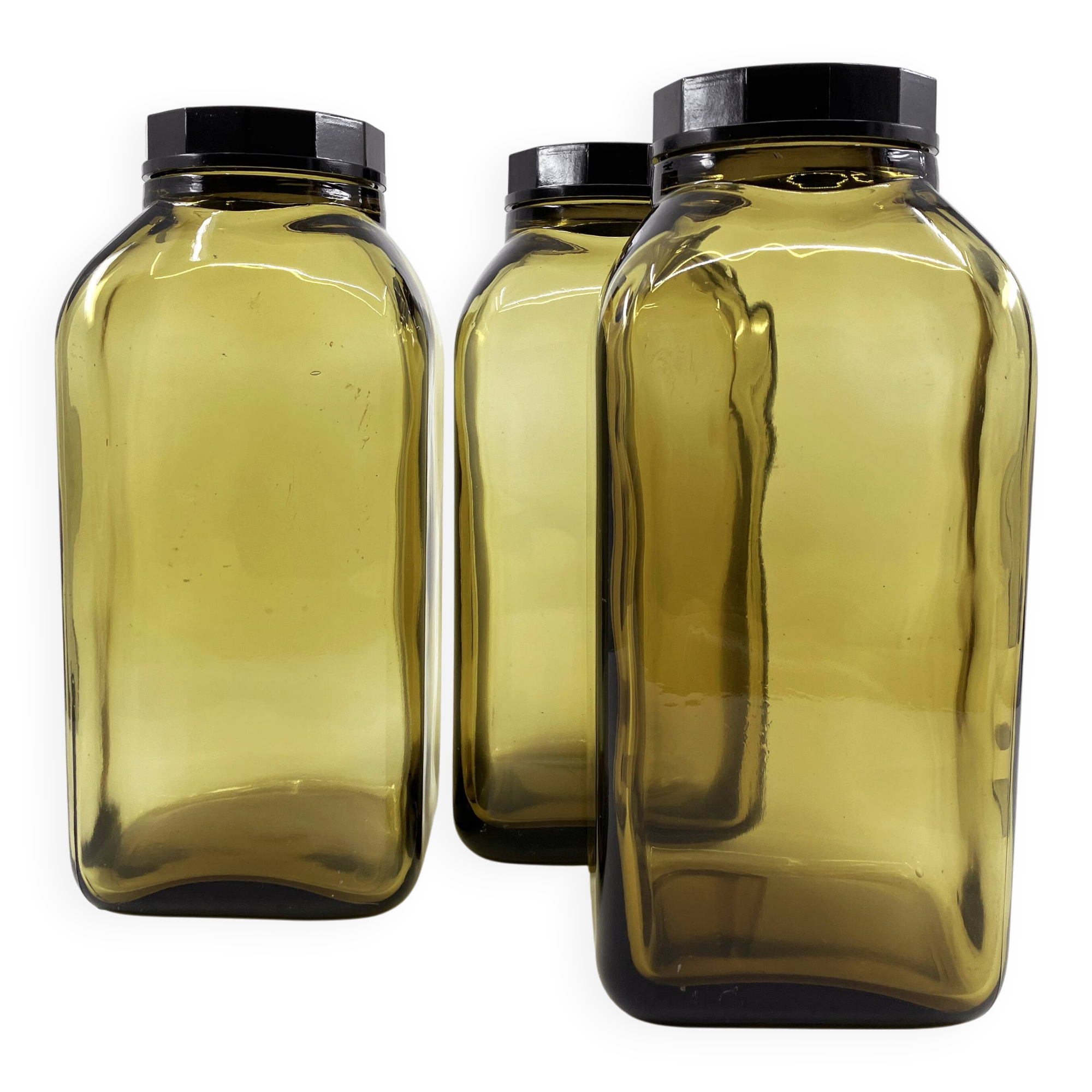 3 molded amber glass pharmacy bottles • Bakelite stoppers • 1950