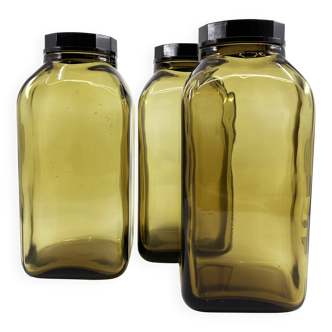3 molded amber glass pharmacy bottles • Bakelite stoppers • 1950