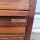 Vintage 1940s secretary desk with wooden curtains, storage, and shutters.