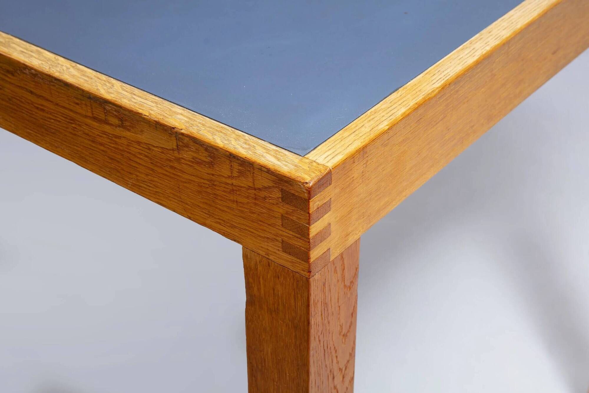 Pine table with a top covered in linoleum.