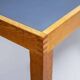 Pine table with a top covered in linoleum.