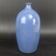 Signed enamelled terracotta bottle vase