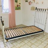 Old white metal and brass bed