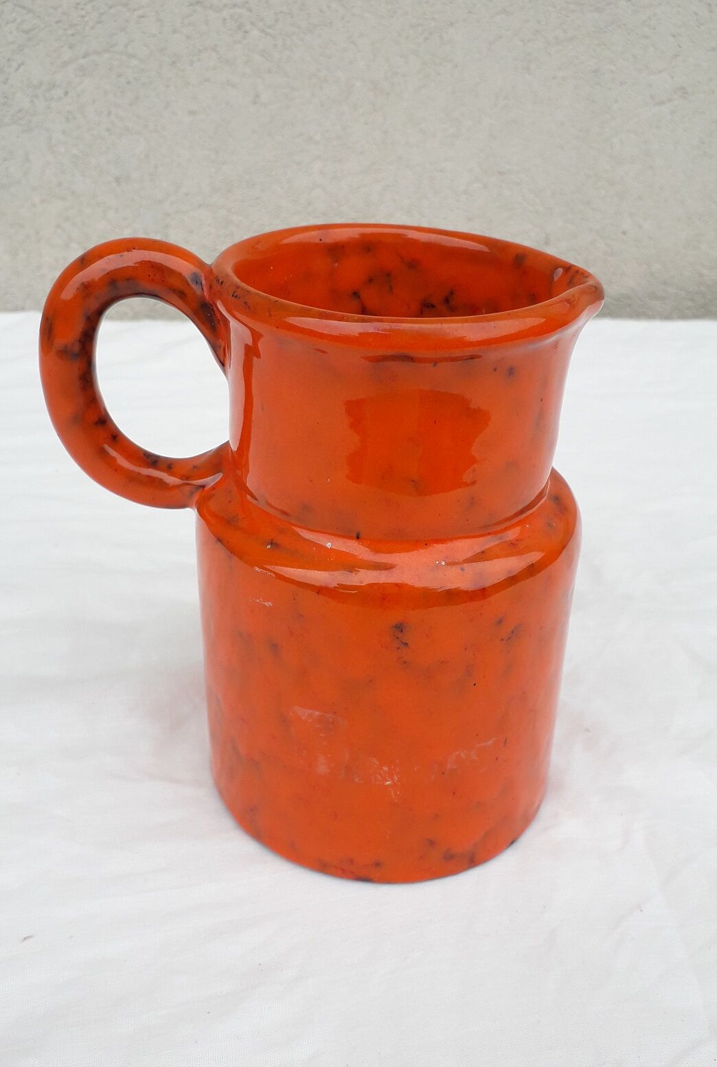 Orange ceramic pitcher