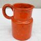 Orange ceramic pitcher