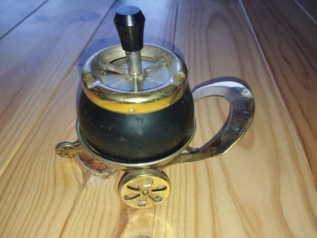 Original vintage ashtray on a small wheeled stand.