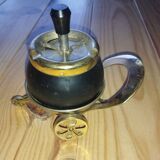 Original vintage ashtray on a small wheeled stand.