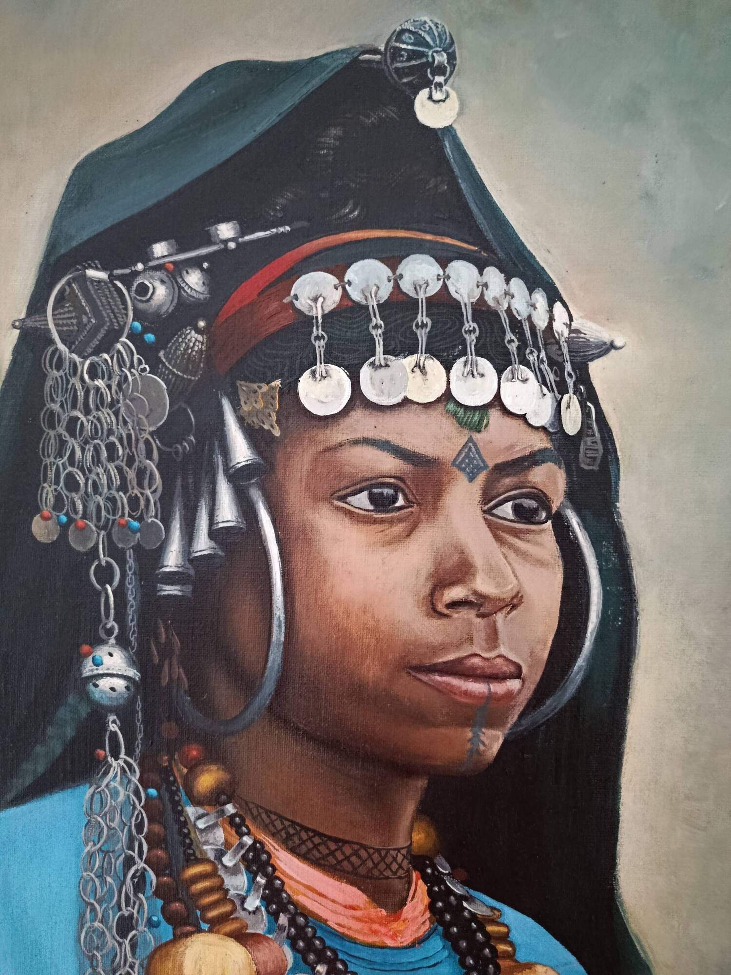 Portrait of a young Moroccan woman in traditional attire and adornments.