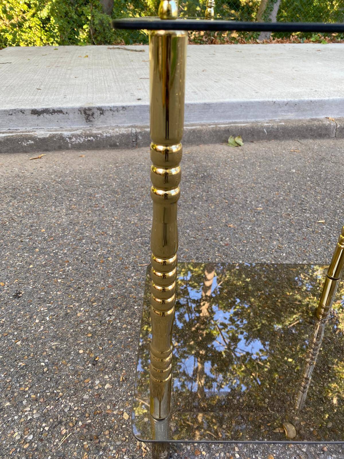 Vintage side table with smoked glass and sculpted golden brass, Hollywood Regency style.