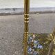 Vintage side table with smoked glass and sculpted golden brass, Hollywood Regency style.