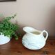 Old bulbous jug in ironstone earthenware