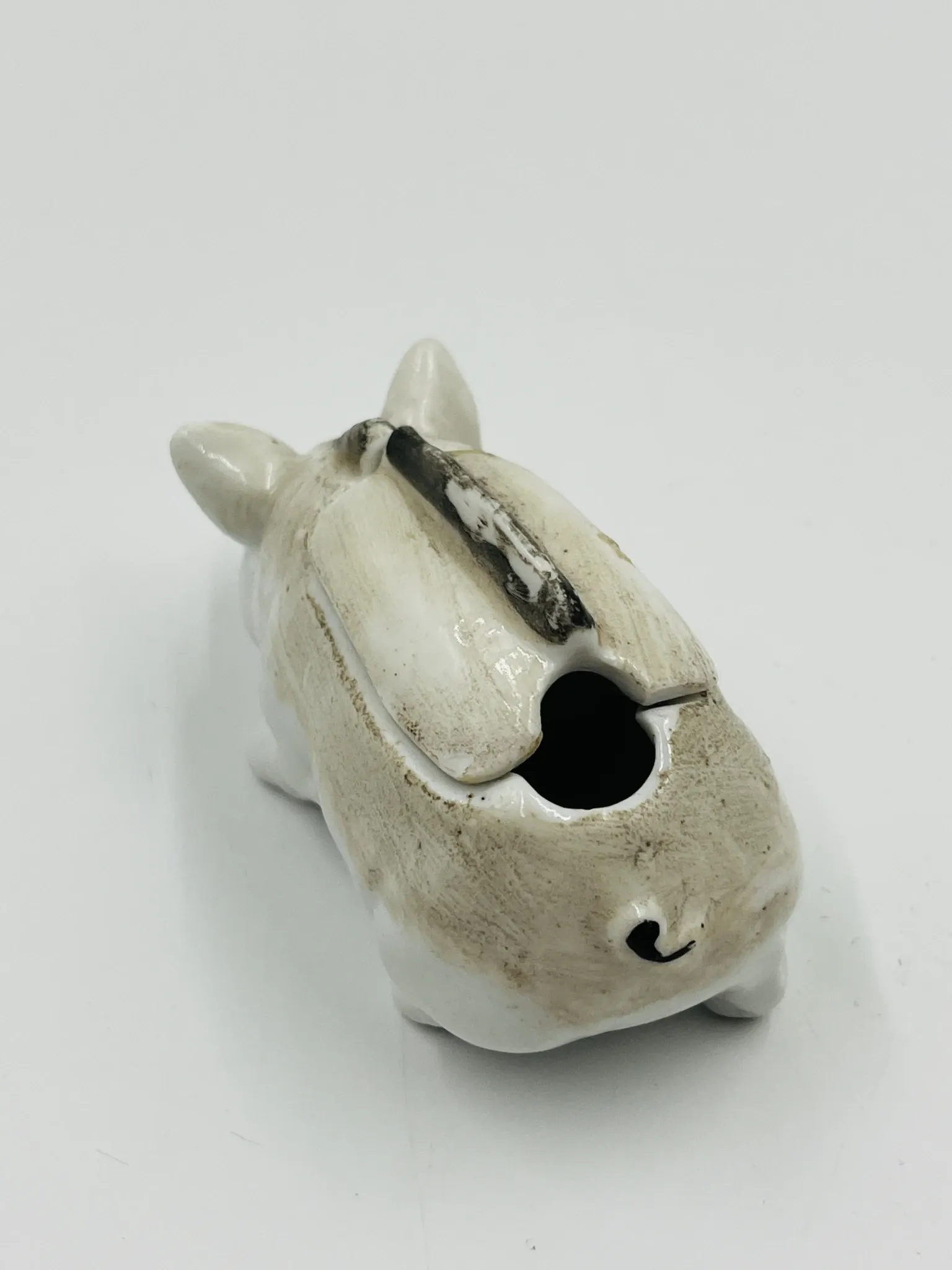 Vintage mustard pot in porcelain shaped like a pig.