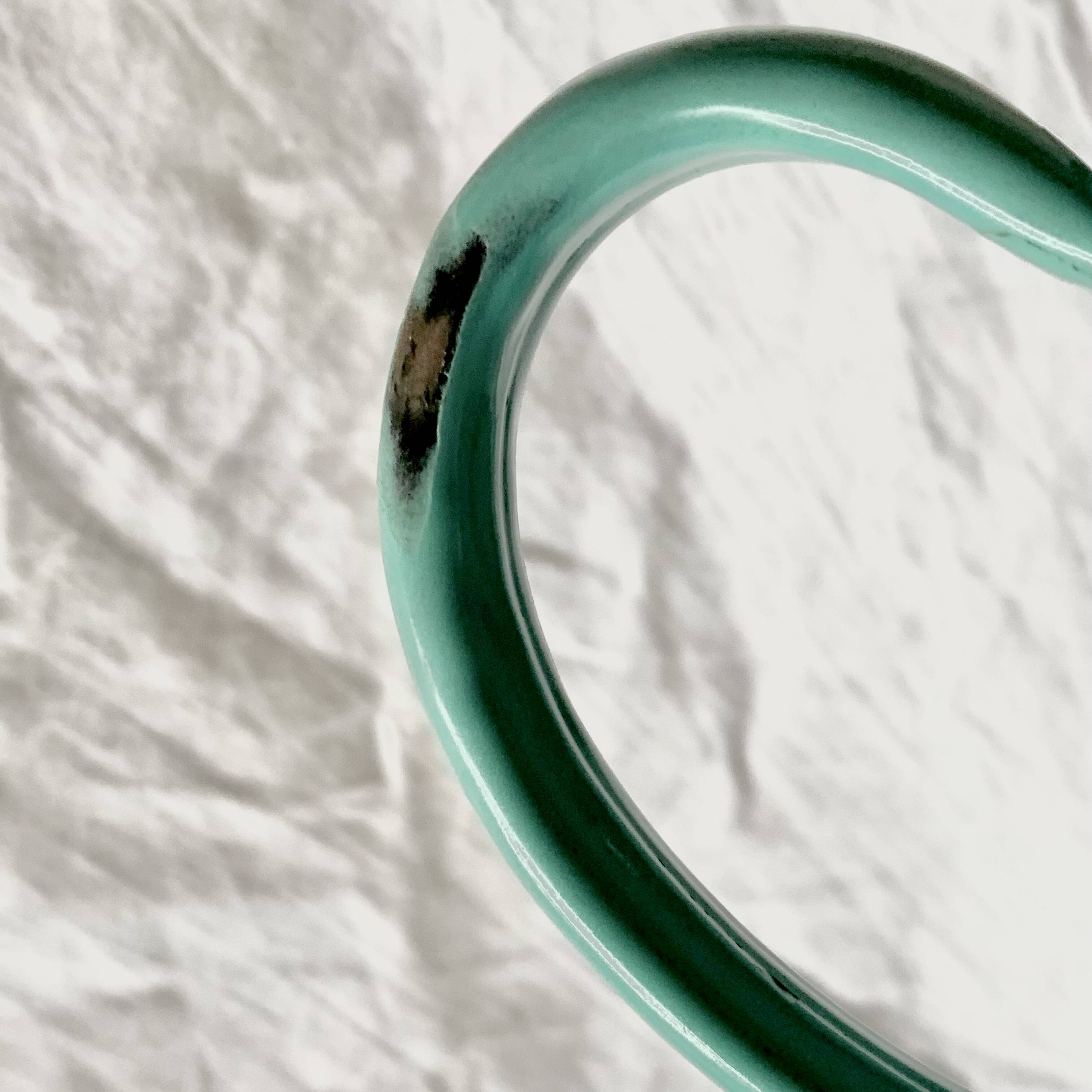 Vintage pitcher in green enameled sheet metal