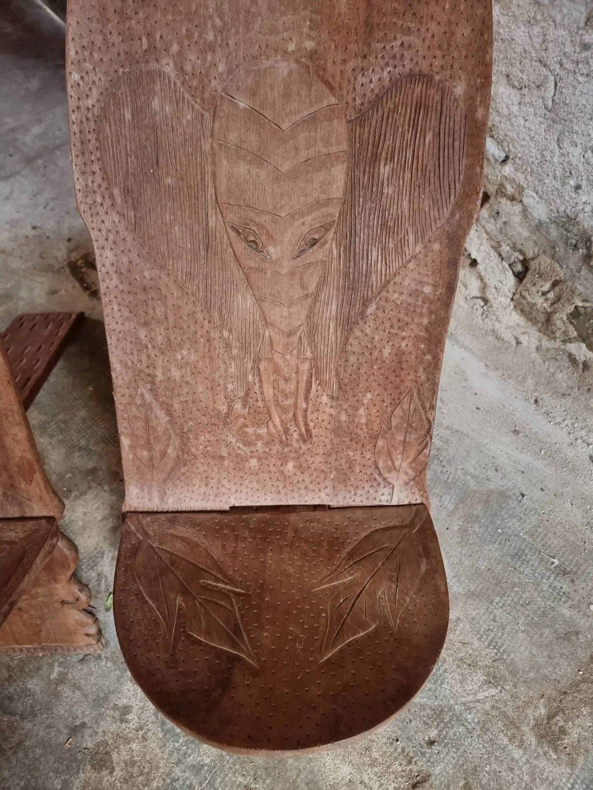 Pair of hand-carved wooden folding chairs – African origin, animal and face motifs, mid-20th century